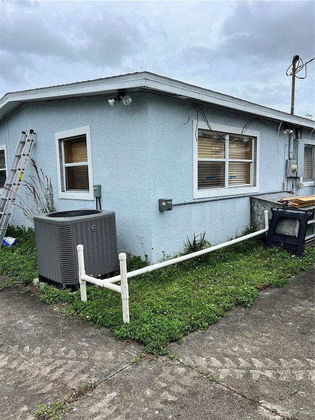 view of home's exterior with central AC unit