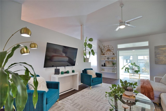 living room with hardwood / wood-style flooring, lofted ceiling, and ceiling fan