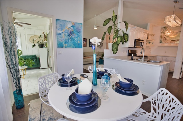 dining space featuring ceiling fan, lofted ceiling, and hardwood / wood-style floors