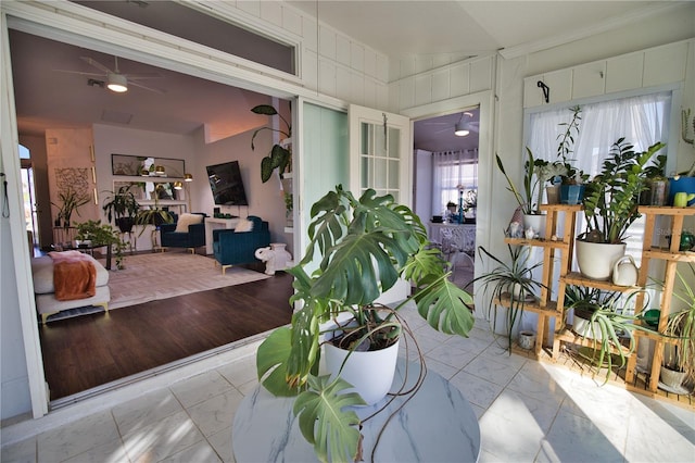 sunroom / solarium with ceiling fan