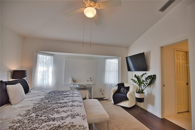 bedroom featuring ceiling fan, lofted ceiling, and hardwood / wood-style floors