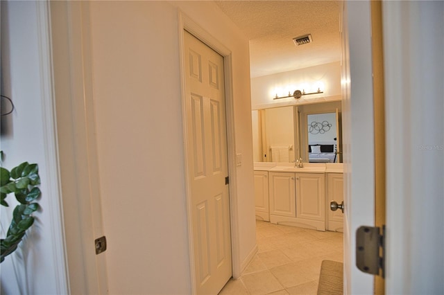 bathroom with vanity and a textured ceiling