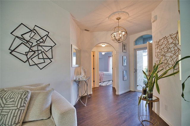 entryway featuring an inviting chandelier and dark hardwood / wood-style flooring