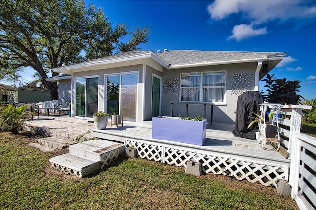 rear view of property featuring a deck