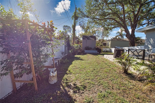 view of yard with a storage unit