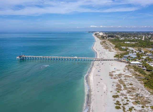 bird's eye view with a water view and a beach view