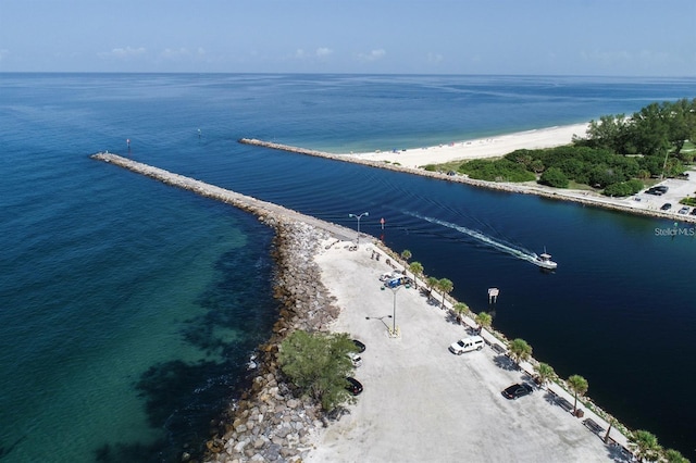 drone / aerial view featuring a water view and a view of the beach