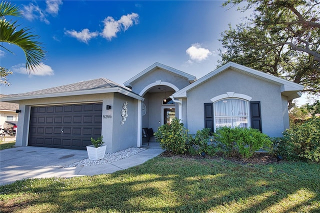 ranch-style home with a front yard and a garage