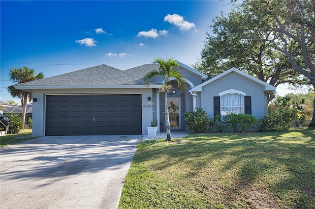 ranch-style house with a garage and a front yard