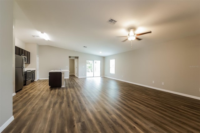 unfurnished living room with vaulted ceiling, ceiling fan, sink, and dark hardwood / wood-style flooring