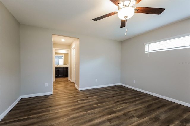 unfurnished room featuring ceiling fan and dark hardwood / wood-style flooring