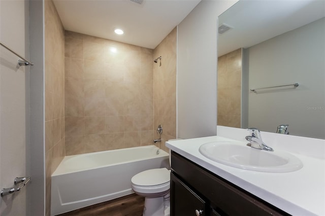 full bathroom with wood-type flooring, toilet, vanity, and tiled shower / bath