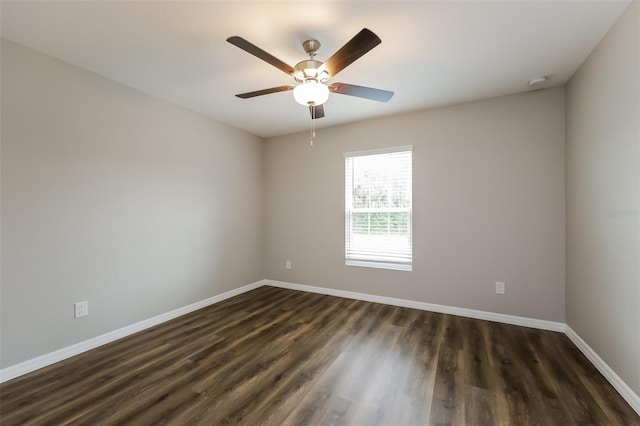 unfurnished room with dark hardwood / wood-style flooring and ceiling fan