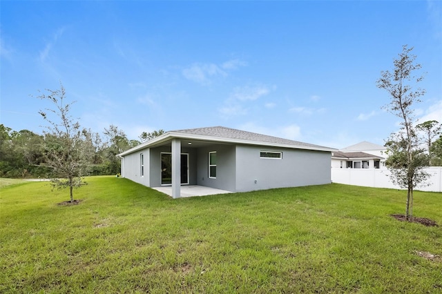 back of house featuring a yard and a patio area