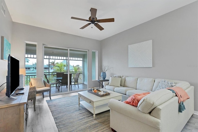 living room featuring hardwood / wood-style floors and ceiling fan