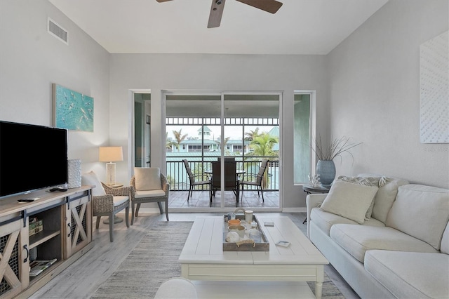 living room with ceiling fan and light hardwood / wood-style floors