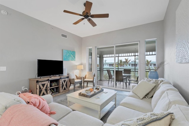 living room with ceiling fan and light wood-type flooring