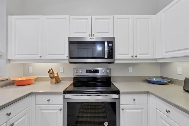 kitchen featuring white cabinets and appliances with stainless steel finishes