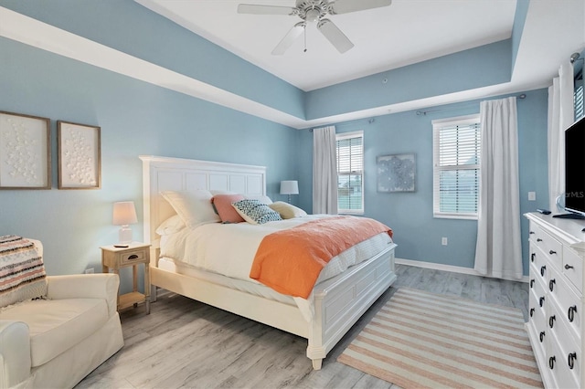 bedroom with light hardwood / wood-style flooring and ceiling fan