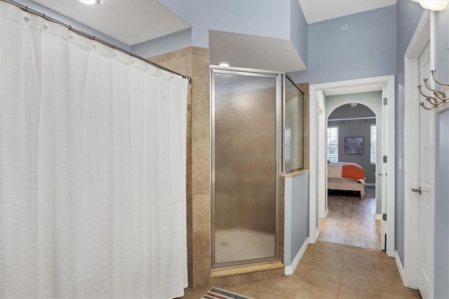 bathroom featuring tile patterned floors and a tile shower