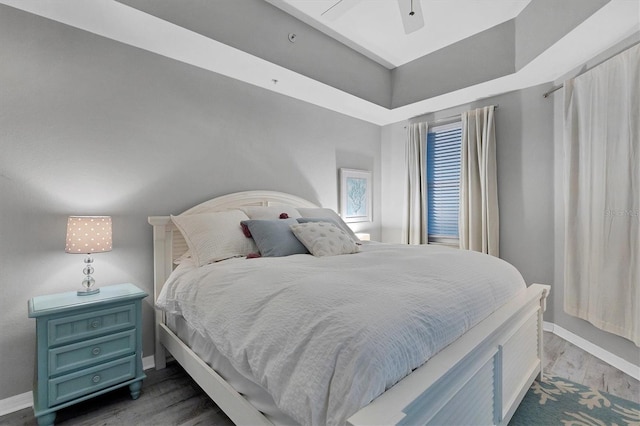 bedroom with ceiling fan and dark hardwood / wood-style flooring