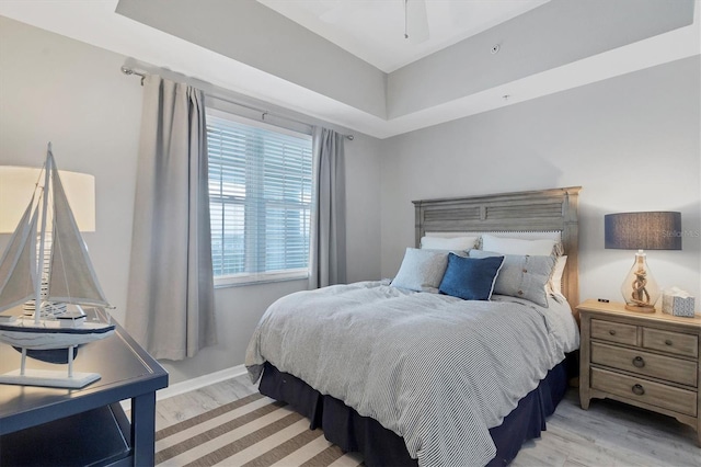 bedroom with light wood-type flooring and ceiling fan