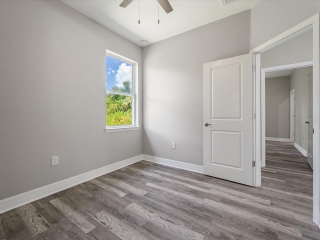 spare room featuring light wood-type flooring and ceiling fan