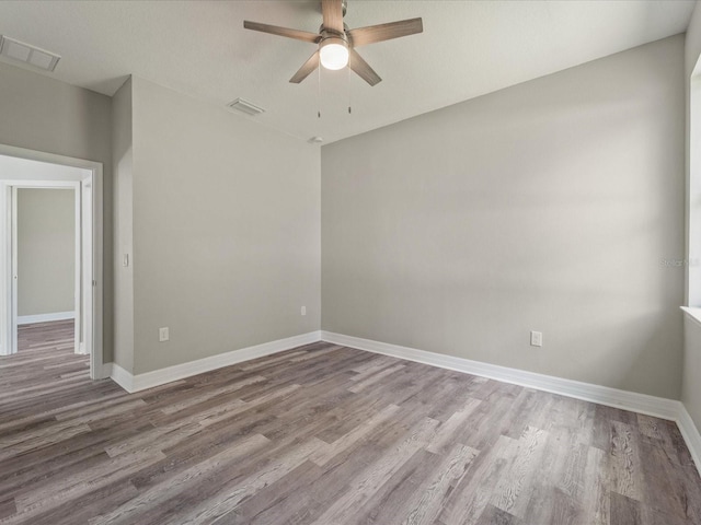 unfurnished room with hardwood / wood-style floors, ceiling fan, and a textured ceiling