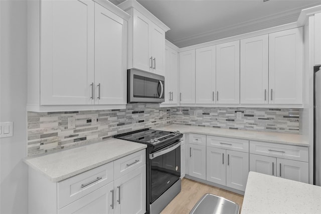 kitchen with white cabinetry, light stone counters, backsplash, black electric range, and light wood-type flooring