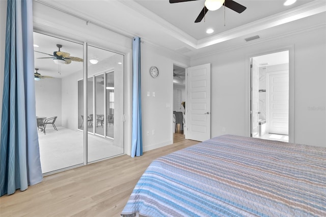 bedroom with ceiling fan, a raised ceiling, light wood-type flooring, and crown molding