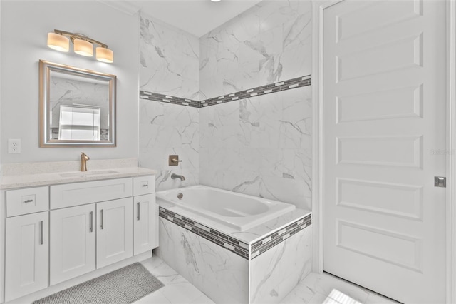 bathroom featuring vanity and tiled tub