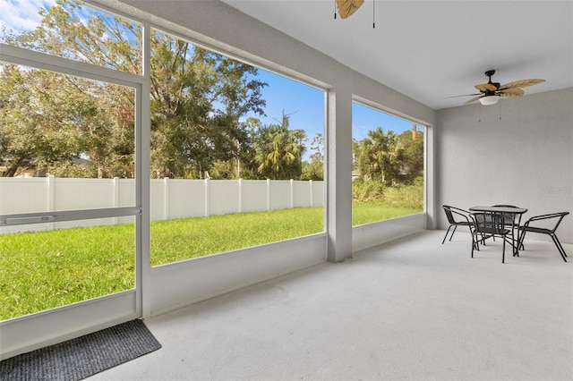 sunroom featuring ceiling fan