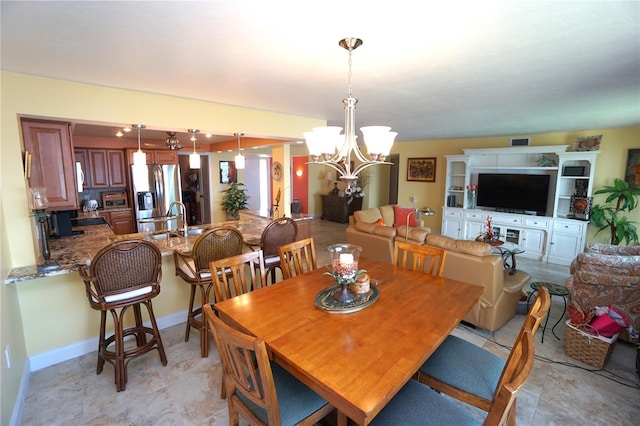 dining space with sink and an inviting chandelier