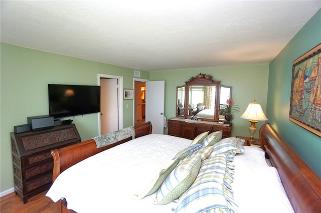 bedroom with hardwood / wood-style floors