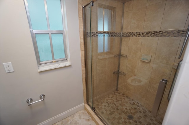 bathroom featuring a shower with door