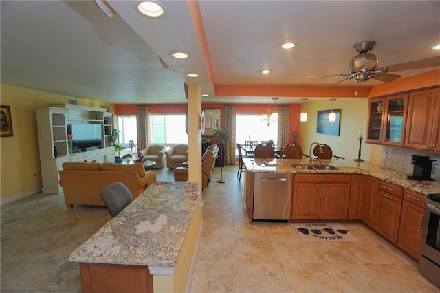 kitchen featuring plenty of natural light, sink, stainless steel appliances, and hanging light fixtures