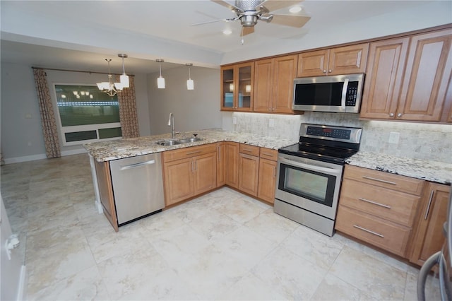 kitchen with light stone countertops, kitchen peninsula, backsplash, stainless steel appliances, and sink