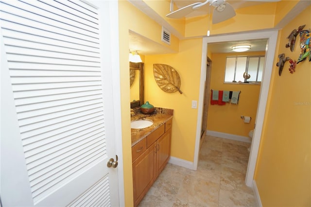 bathroom featuring a shower with door and vanity