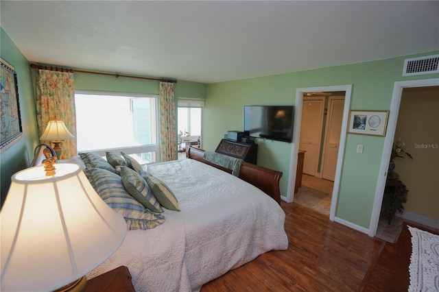 bedroom with dark wood-type flooring