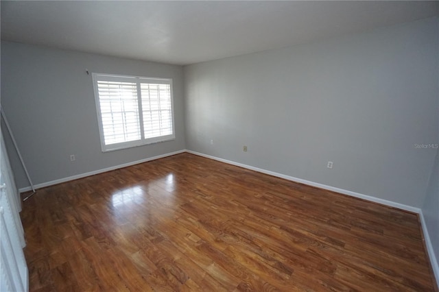 unfurnished room featuring dark hardwood / wood-style flooring