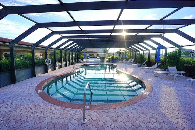 view of pool with a patio and glass enclosure