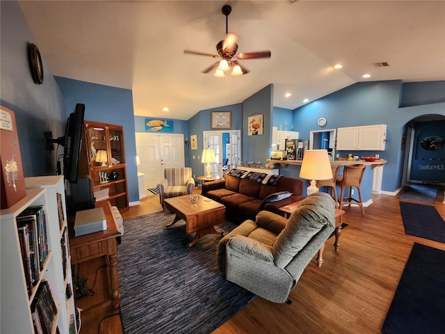 living room featuring ceiling fan, light hardwood / wood-style flooring, and lofted ceiling