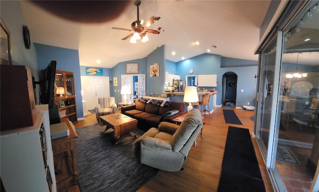 living room with light hardwood / wood-style flooring, ceiling fan, and vaulted ceiling