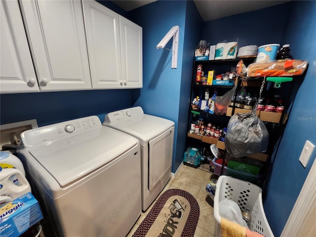 washroom with cabinets, separate washer and dryer, and light tile patterned floors