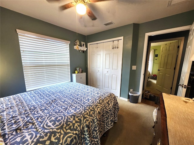 carpeted bedroom featuring ceiling fan and a closet