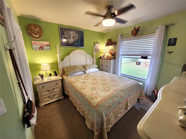 bedroom with dark colored carpet and ceiling fan