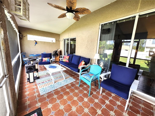 sunroom with lofted ceiling and ceiling fan