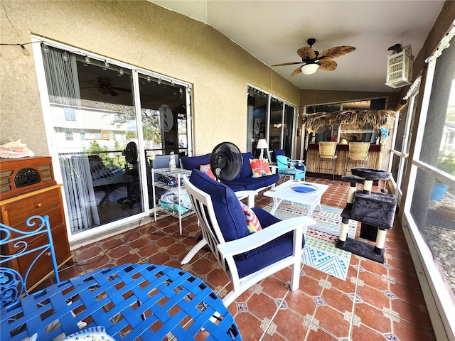 sunroom with ceiling fan and vaulted ceiling