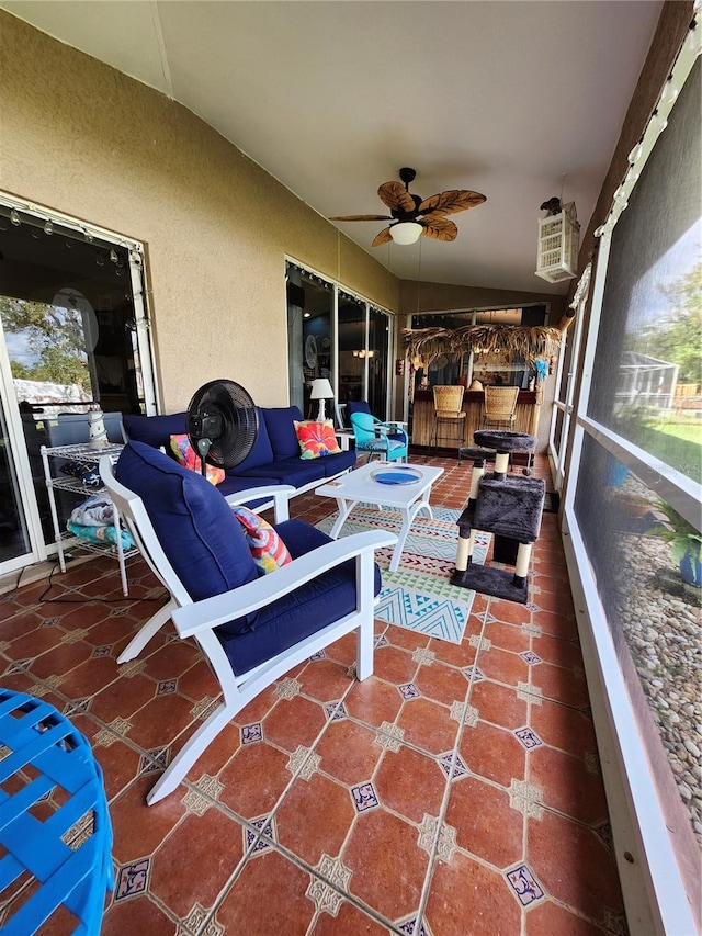 sunroom / solarium featuring vaulted ceiling and ceiling fan