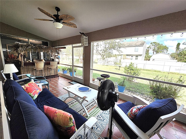 sunroom / solarium featuring vaulted ceiling and ceiling fan